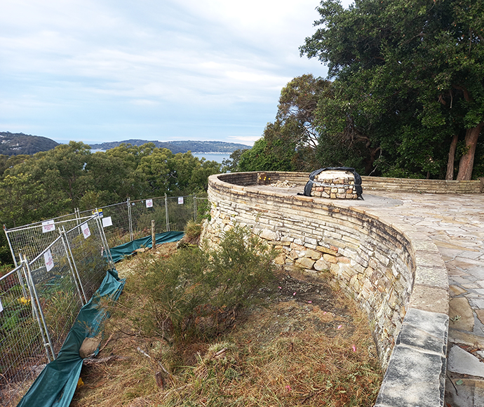 The existing sandstone retaining wall that is being rebuilt along the lower perimeter of the main viewing area