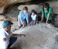 Aboriginal Discovery Ranger Paddy Chatfield with children at Sandstone Caves
