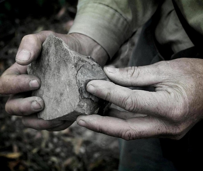 Eric Keidge holds a stone tool fitted back together during a visit to an Aboriginal site in Oxley Wild Rivers National Park, Anaiwan/Gumbaynggirr Country. 