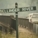 Bellinget River sign in the foreground and bridge and 4WD vehicle in the background. The Bellinger River snapping turtle is only found in a 60-kilometre stretch of the river