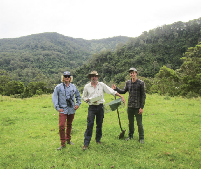 Staff and volunteers pose in front of Quollidor habitat buffer during BioBlitz