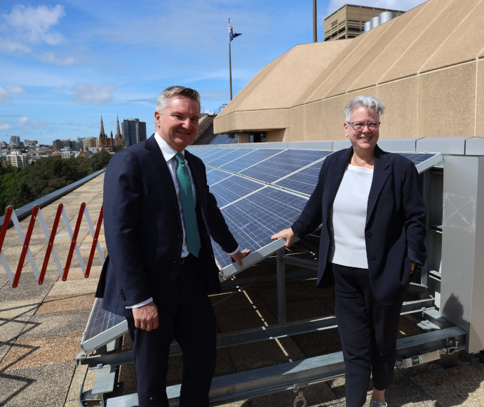 Chris Bowen and Penny Sharpe on Parliament House roof with solar panels.