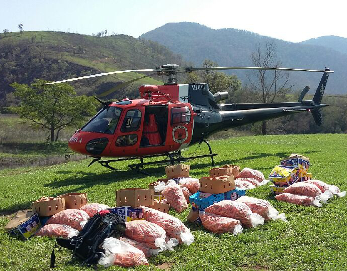 National Parks and Wildlife Service helicopter with bags of donated carrots and sweet potatoes