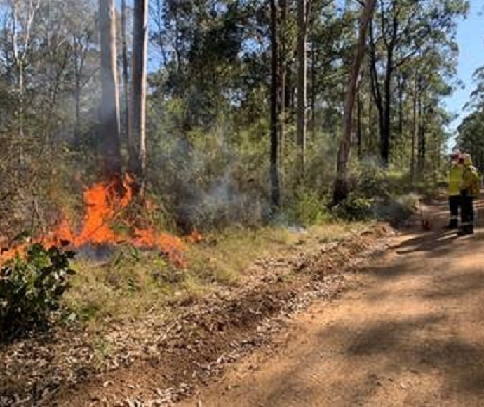 Two fire fighters undertaking a hazard reduction burn in Cessnock area, September 2021