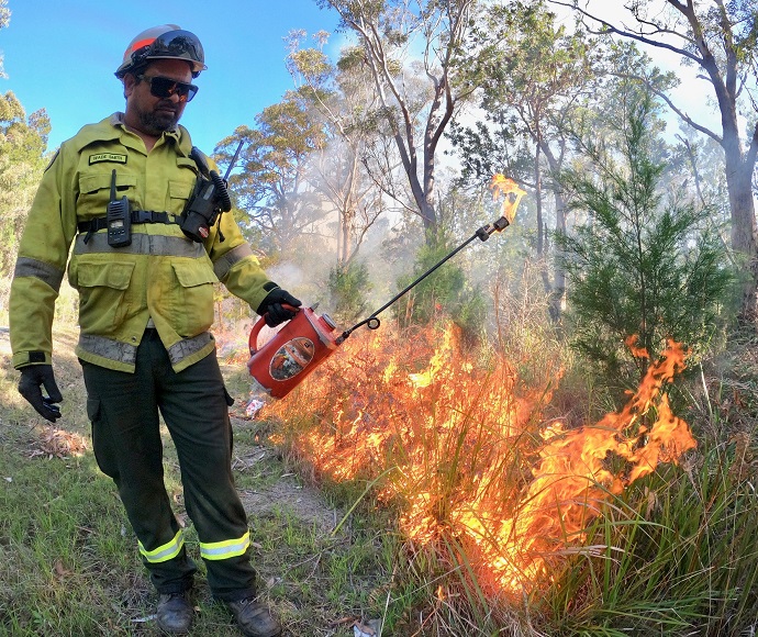 National Parks and Wildlife Service personnel dressed in protective clothing undertakes hazard reduction burning