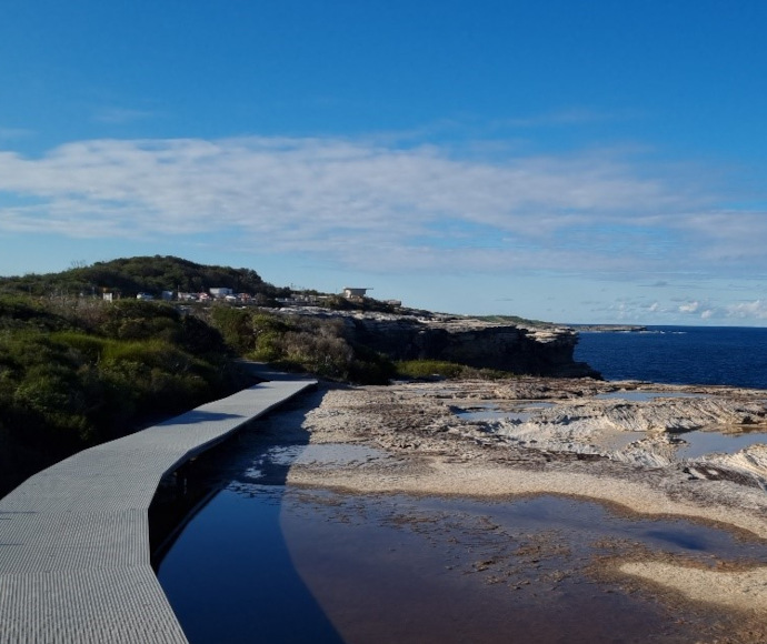 Footbridge section of Cape Baily Walking Track, leading over rockpools by the sea