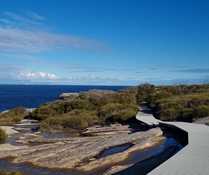 Footbridge section of Cape Baily Walking Track leading over rockpools beside the sea