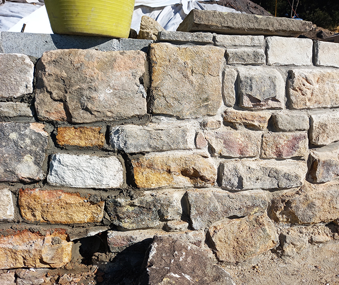A section of the new outer sandstone wall in front of the concrete blockwork wall. 