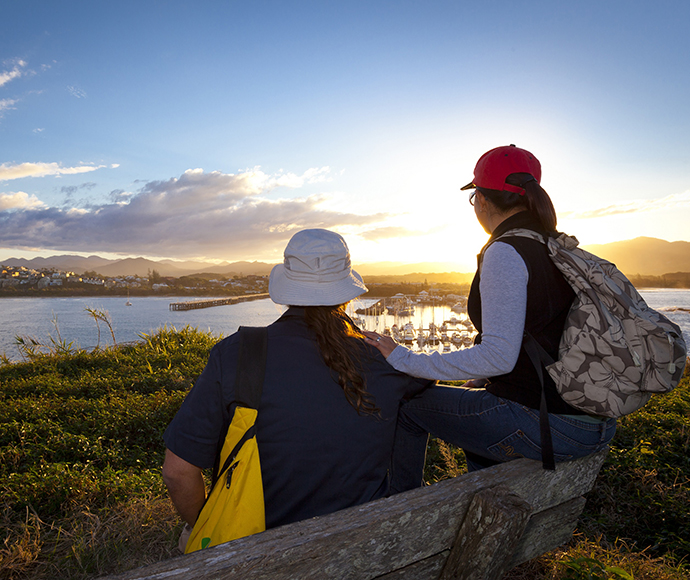 Couple on Solitary Islands Coastal Walk and looking over Coffs Harbour