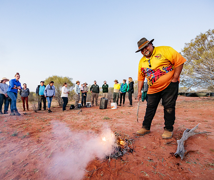 Maljangapa traditional owner Leroy Johnson performing a smoking ceremony to cleanse bilbies and people prior to release of the first 10 bilby founders translocated from the Taronga Conservation Society Australia’s breeding sanctuary in Dubbo to the Wild Deserts site