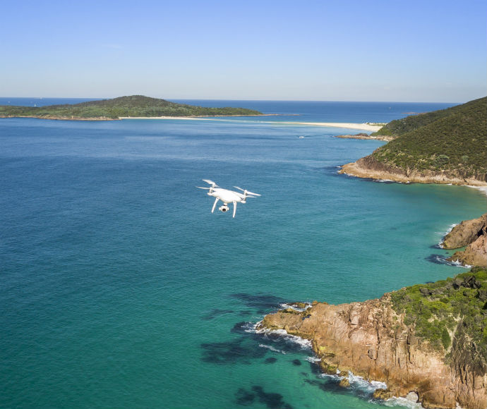 Drone flying above coastline, Tomaree National Park