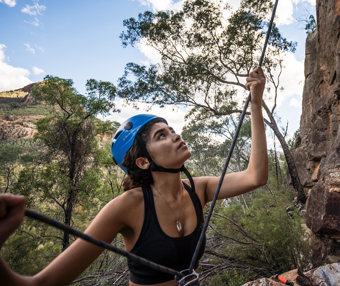 Woman rock climbing, Canyon Picnic Area, Warrumbungle National Park