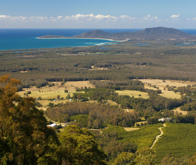 Views across farmland to mountains and the ocean from Yarriabini Lookout in Yarriabini National Park