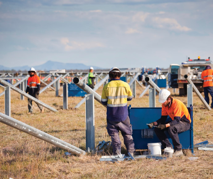 Workers set up solar panels at Moree Solar Farm. Moree, NSW