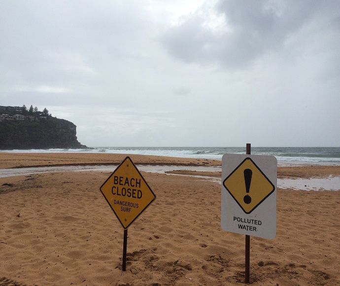 Pollution warning signs on a beach