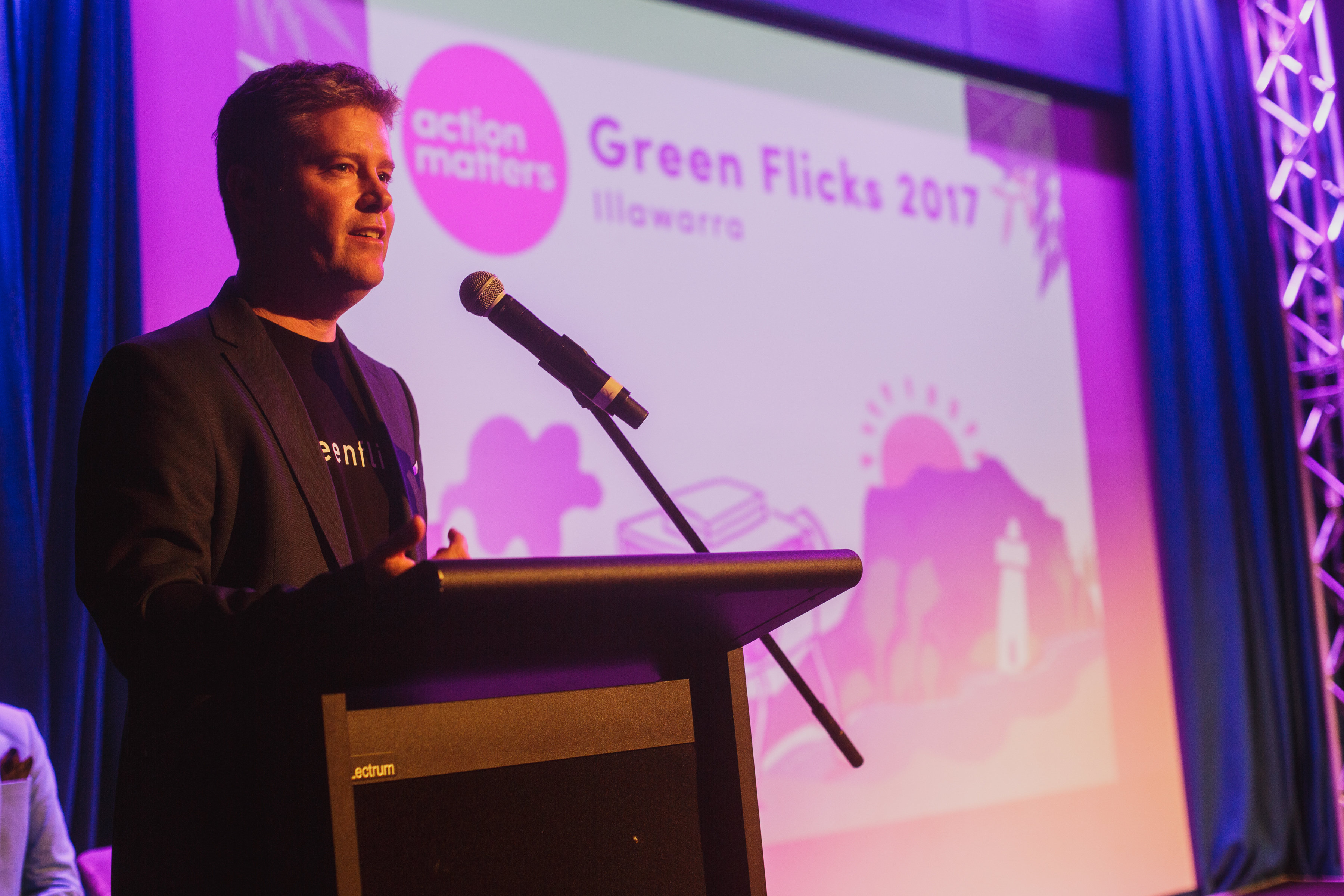 Staff member speaking on stage