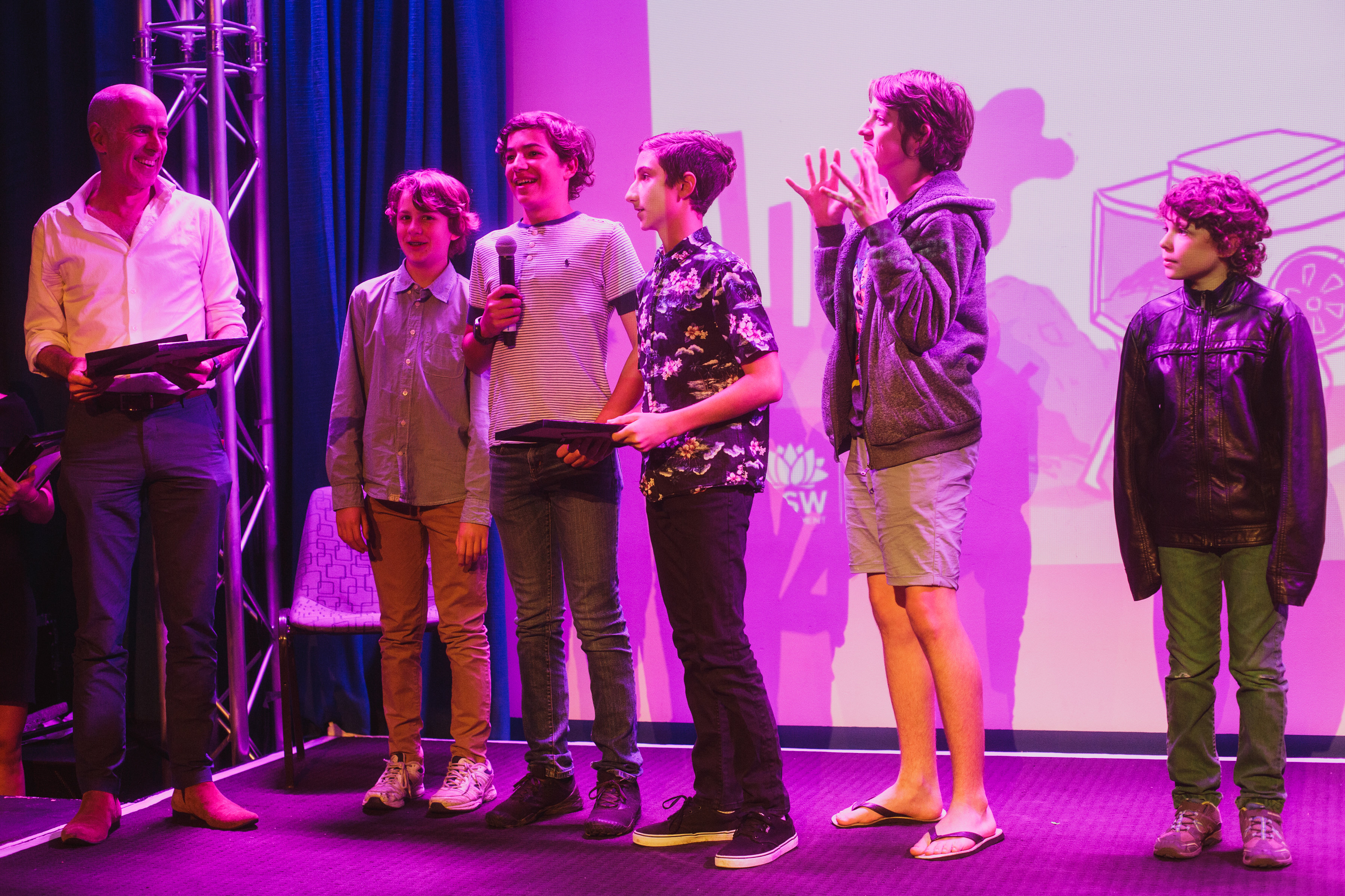Group of five onstage receiving an award