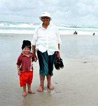 Aunty Bertha Kapeen & her grandchild on the beach at Boundary Creek
