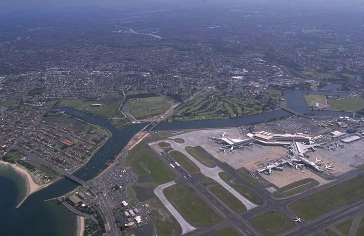 A view of Cooks River flowing into Botany Bay with Sydney International Airport in the foreground