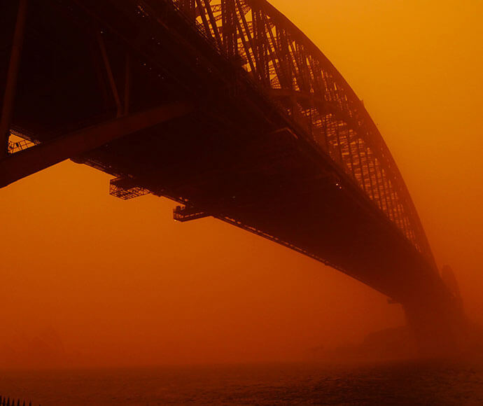 Sydney harbour bridge hardly visible through all the red dust.