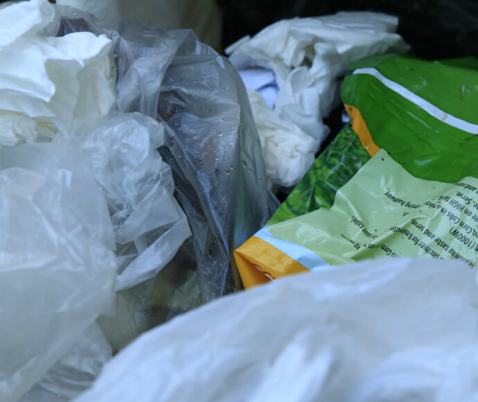 Close up of 5 garbage bags full of waste.