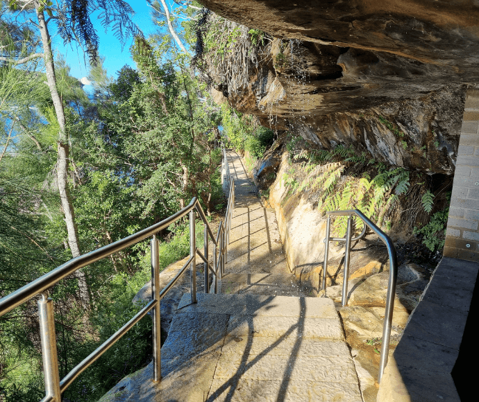 Yellow rock forming a straight pathway surrounded by brown and green bushland