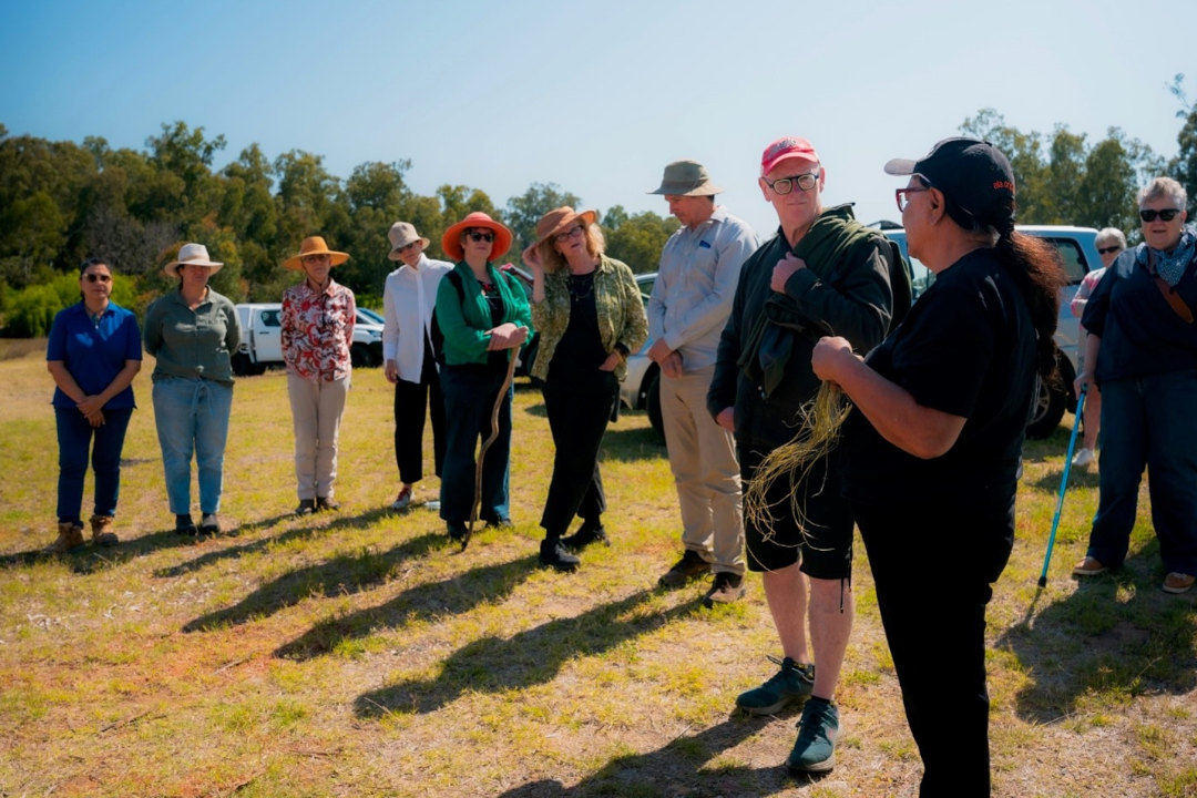 A line of people wearing hats, standing in the outdoors