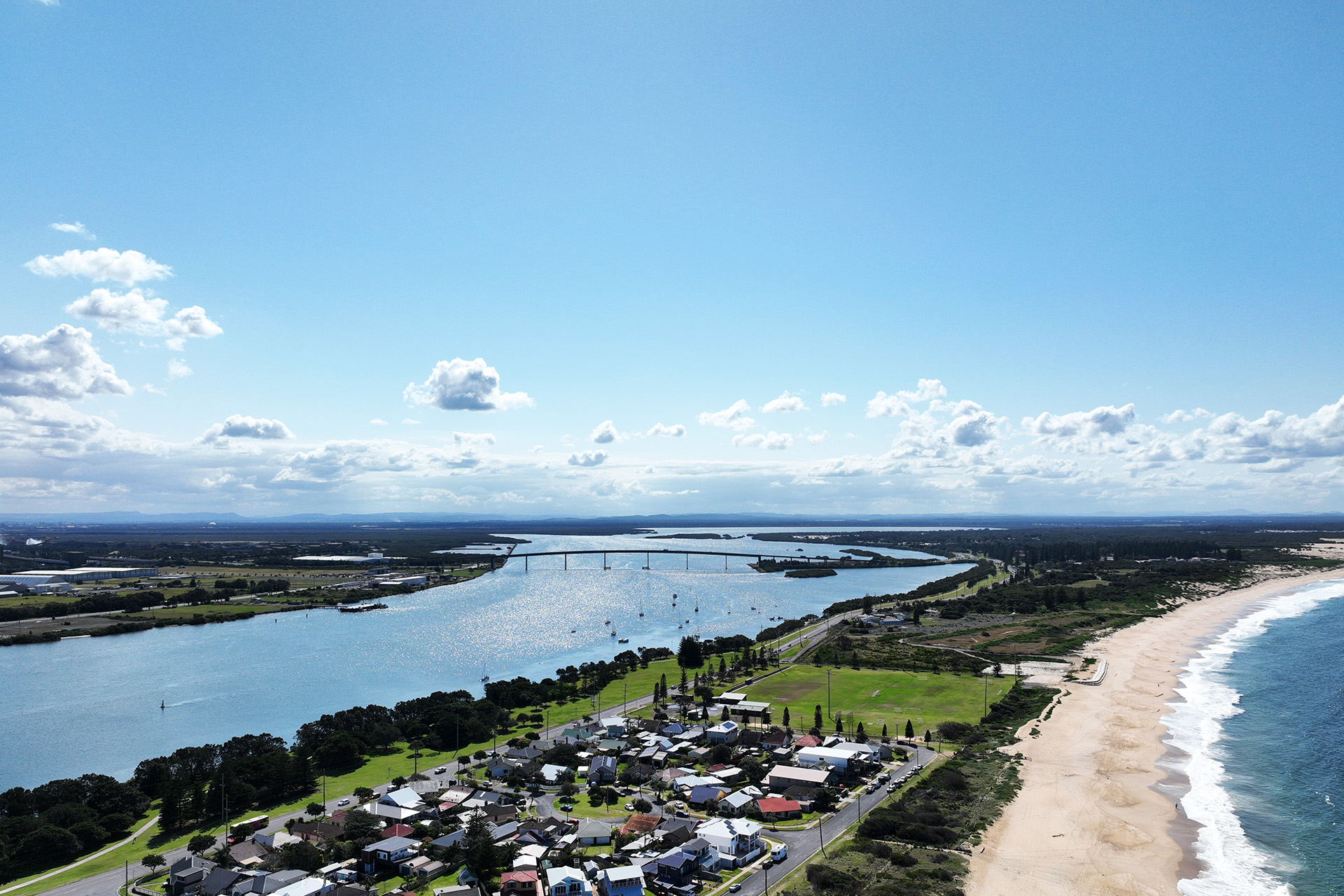 A view of the beach, buildings and estuary