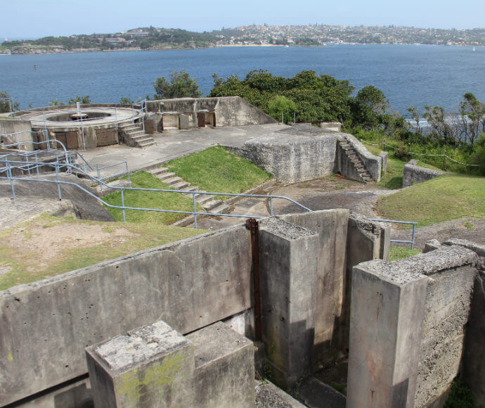Photo of the 1801 Forts at Middle Head in Sydney Harbour National Park. The image features a bright blue sky, and properties in Manly are visible across the harbour.