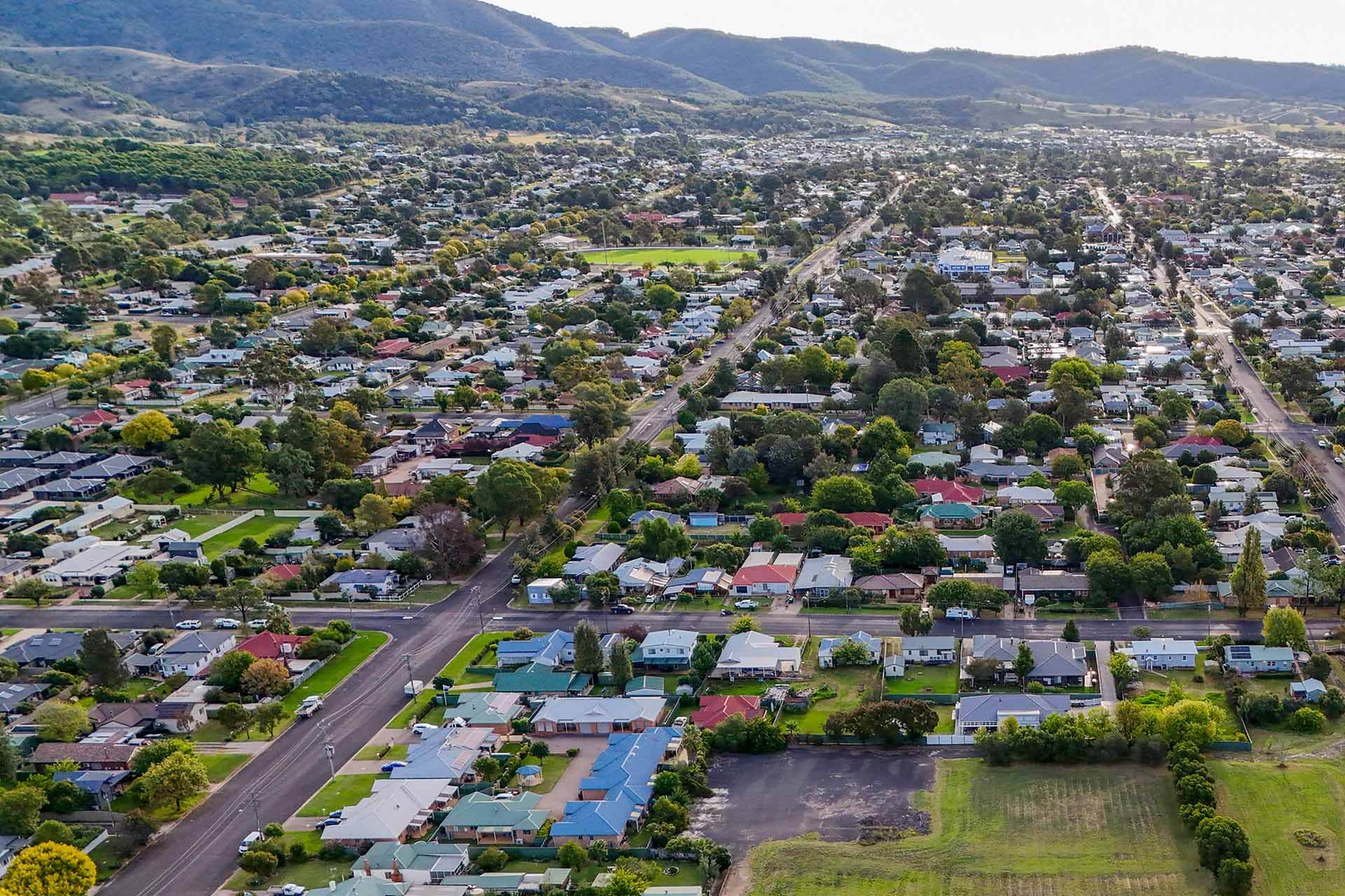 Aerial view of houses, road in foreground.
