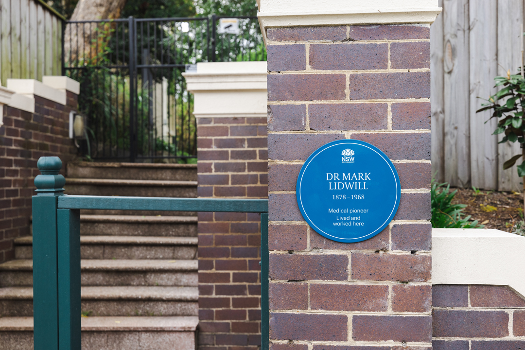 Brick building with Dr Mark Lidwill's blue plaque, reads 'Medical pioneer. Lived and worked here.'