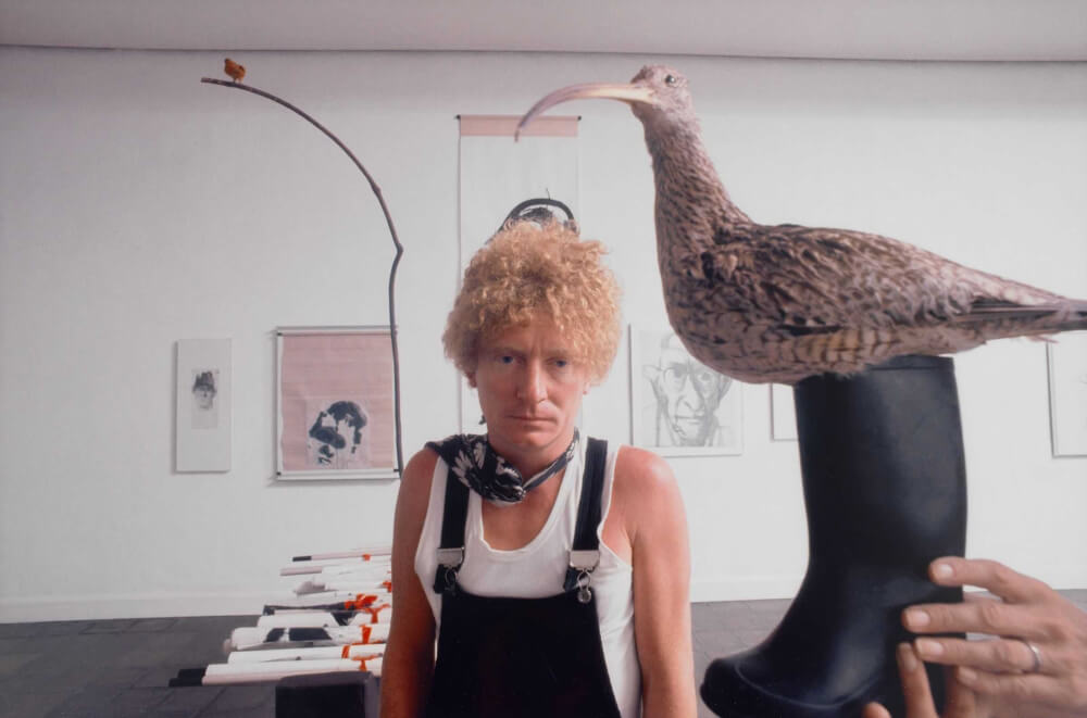 Portrait of artist Brett Whiteley in the studio with taxidermied birds, 1974