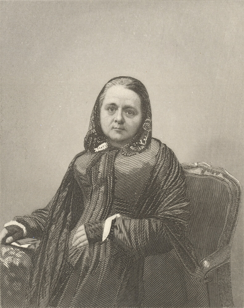 Black and white portrait of Caroline Chisholm by J.B. Hunt, dated 1853. She is seated and wearing a long gown. Her hair is covered by a scarf, giving her a modest and composed appearance. The portrait captures her in a calm and dignified pose.