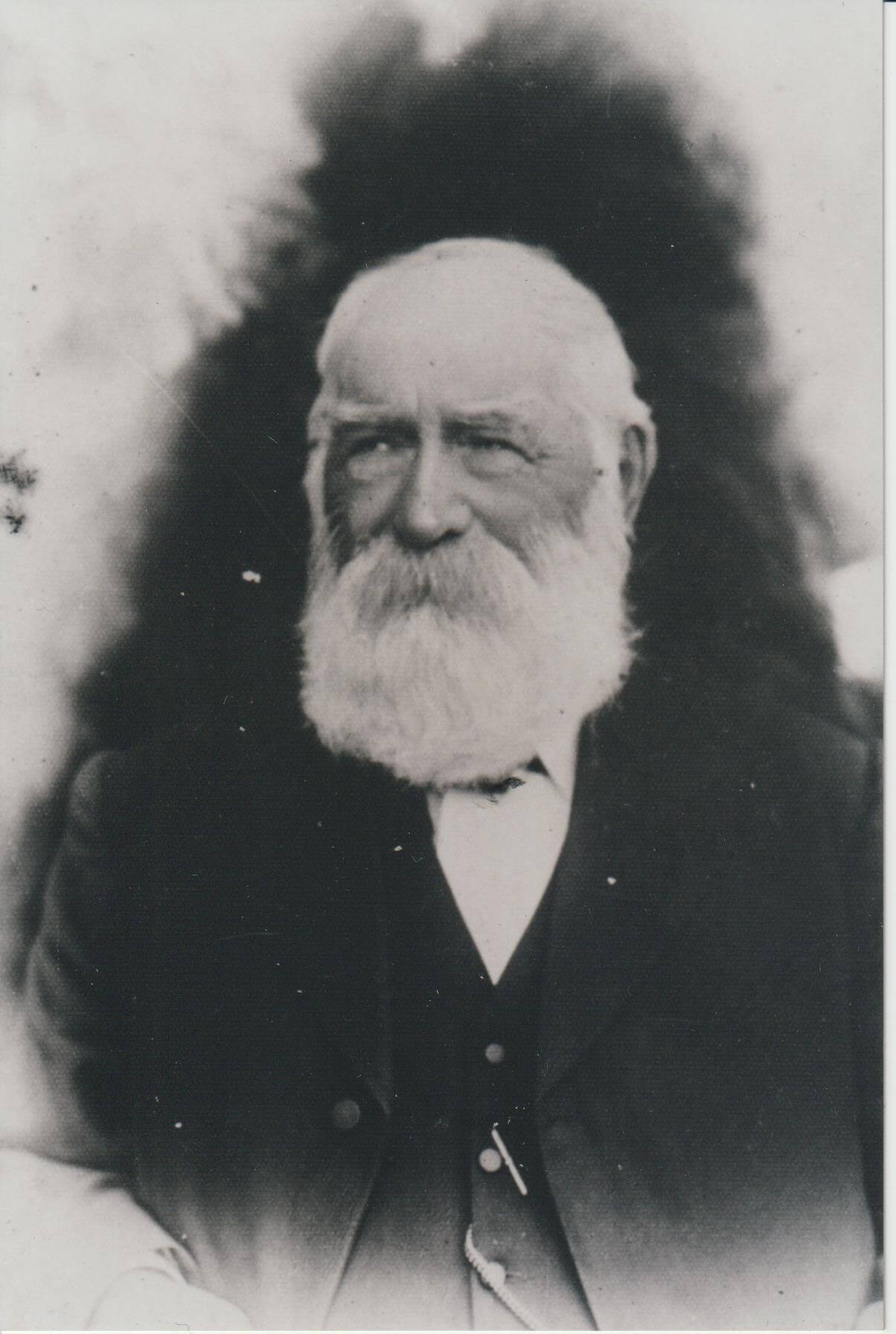Black and white portrait of Daniel Gowing wearing a suit