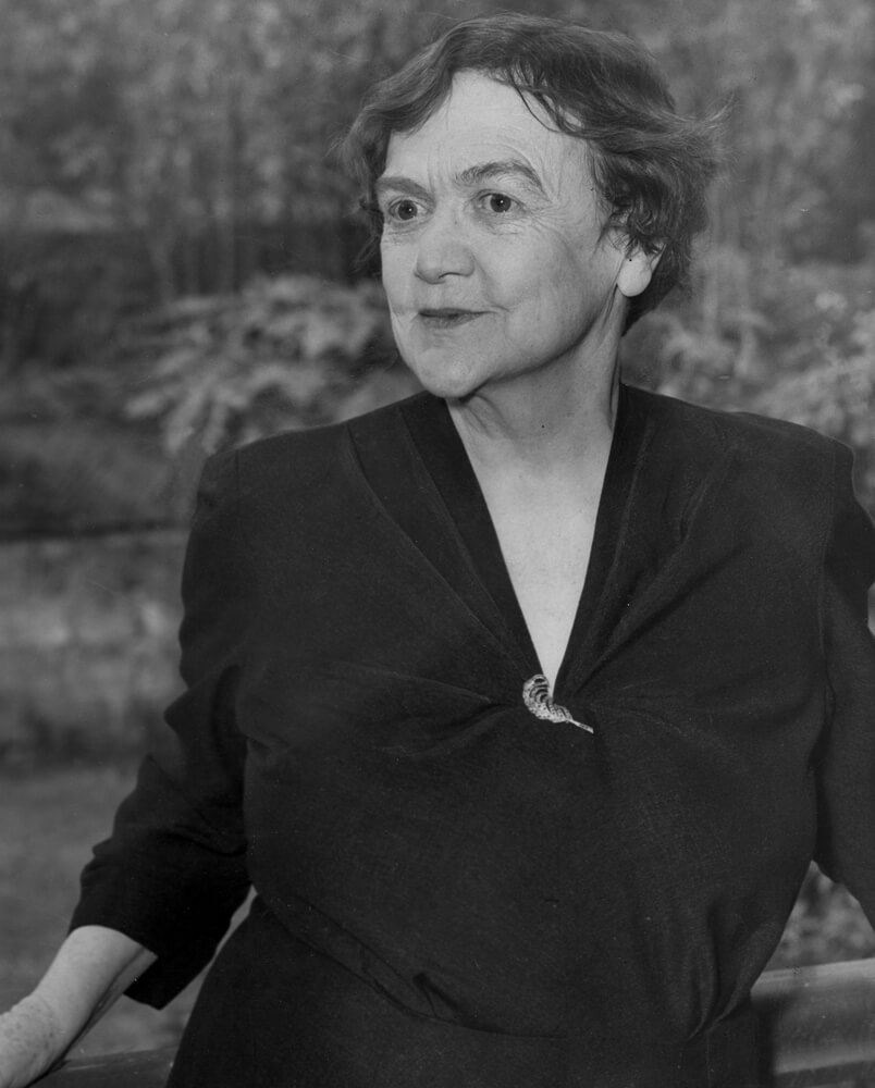 Black and white portrait of Dorothea. Plants in the background.