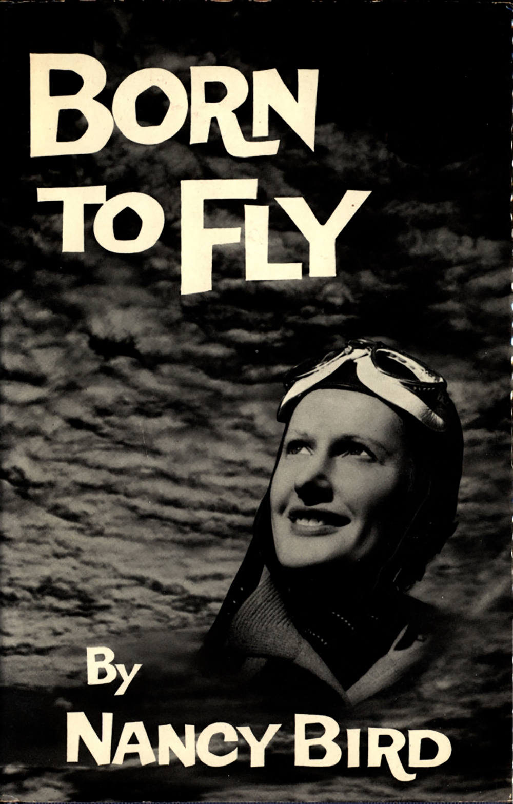 The front cover of one of Nancy Bird’s books. ‘BORN TO FLY’ reads at the top left and ‘BY NANCY BIRD’ reads at the bottom. The cover has an image of Nancy Bird with clouds behind her.