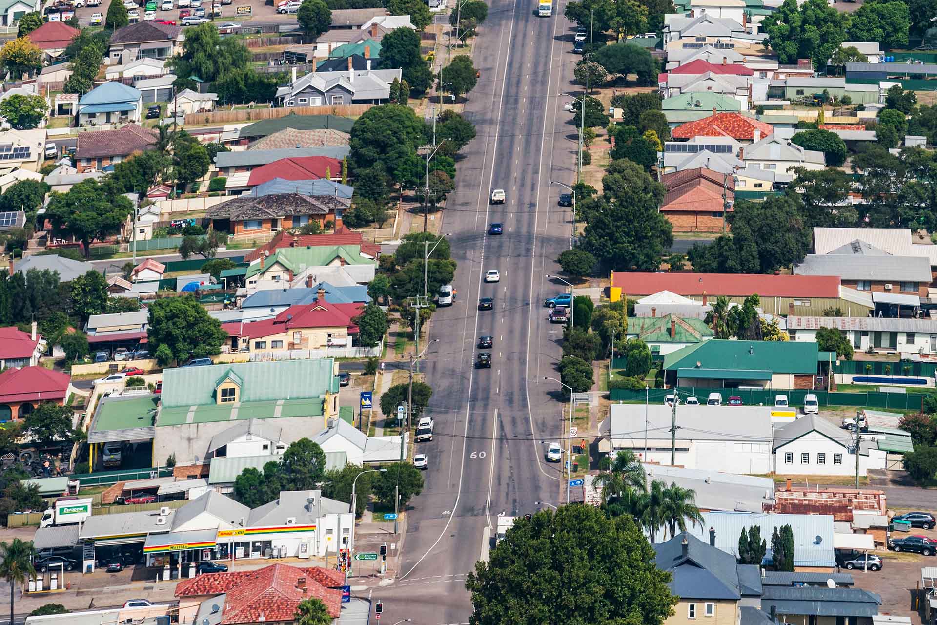 Two-lane road cutting through country town.