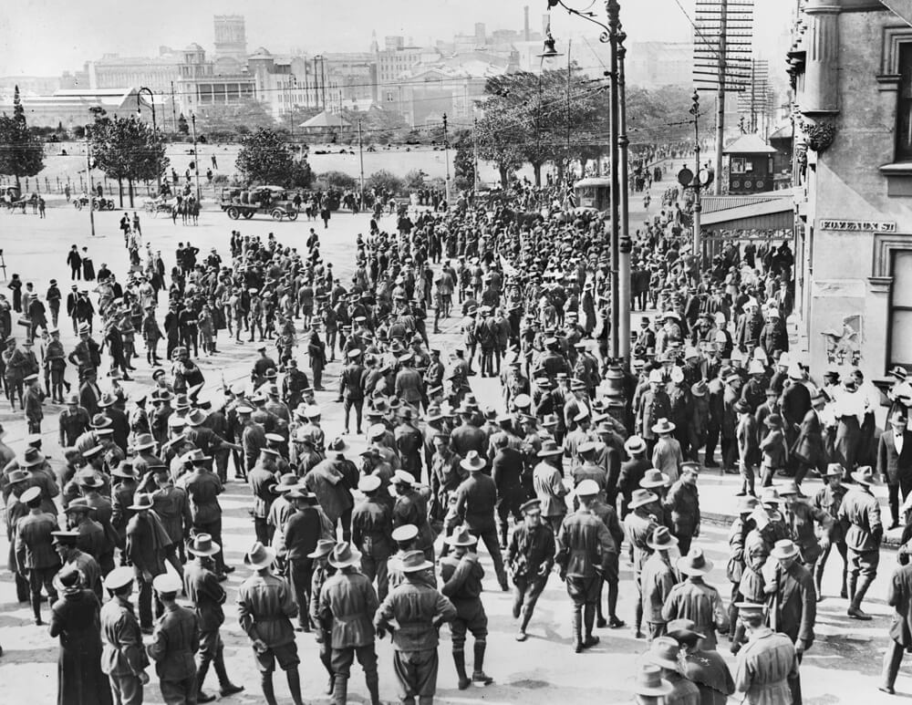 Black and white image of soldiers rioting outside a brewery.