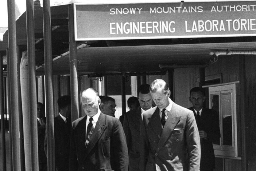 A photograph of Thomas Leech walking with His Royal Highness the Duke of Edinburgh. This photograph was taken when the Duke of Edinburgh visited the Snowy Mountains Authority Engineering Laboratories.