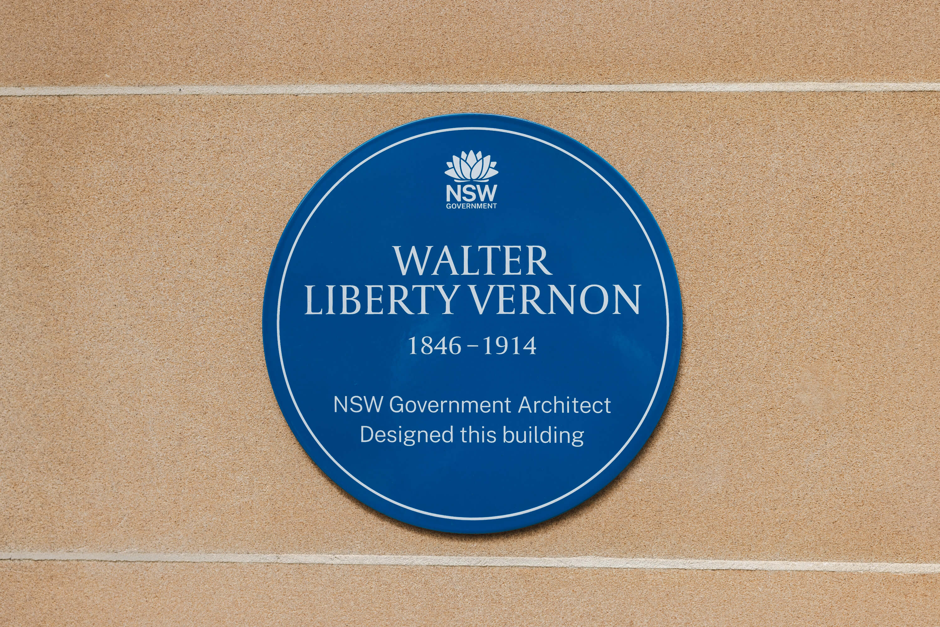 A blue plaque for Walter Liberty Vernon. The plaque reads "NSW Government Architect. Designed this building."
