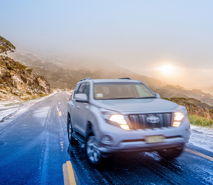 Blurred car on icy Kosciuszko Road at Charlotte Pass