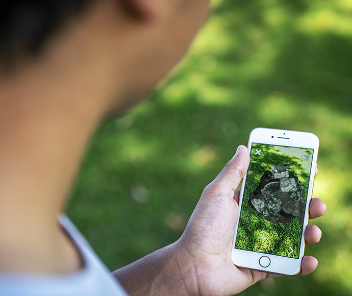 In park looking at augmented reality Gould's petrel with NSW National Parks app