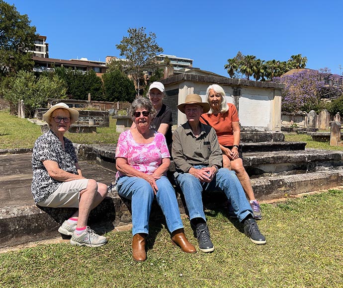 Volunteers sitting on memorial stonework