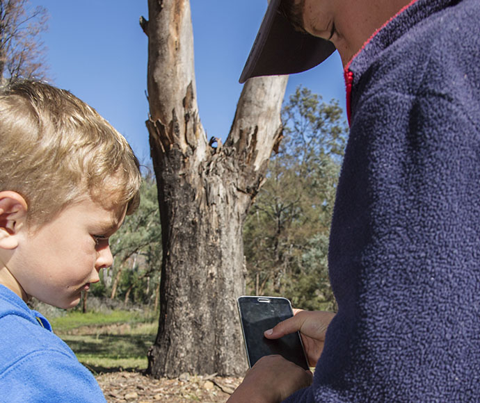 Children taking picture with a mobile phone at Warrumbungle National Park, Burbie Canyon track